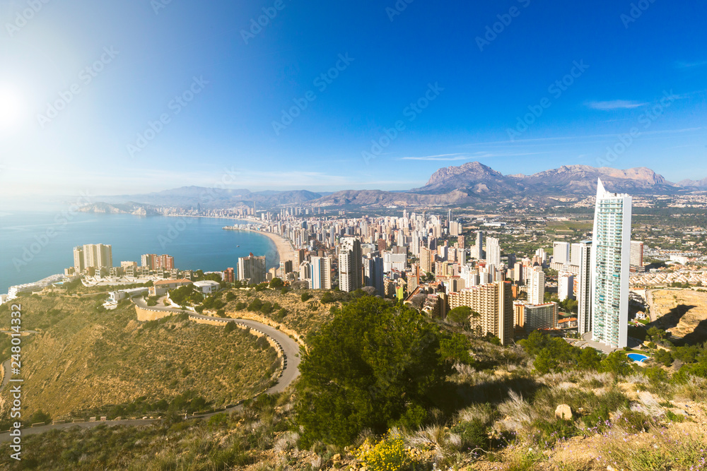 Top view of Benidorm Spain with skyscrapers and mountains and coastline on a sunny day