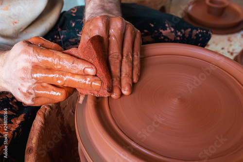 hands of potter on potters wheel