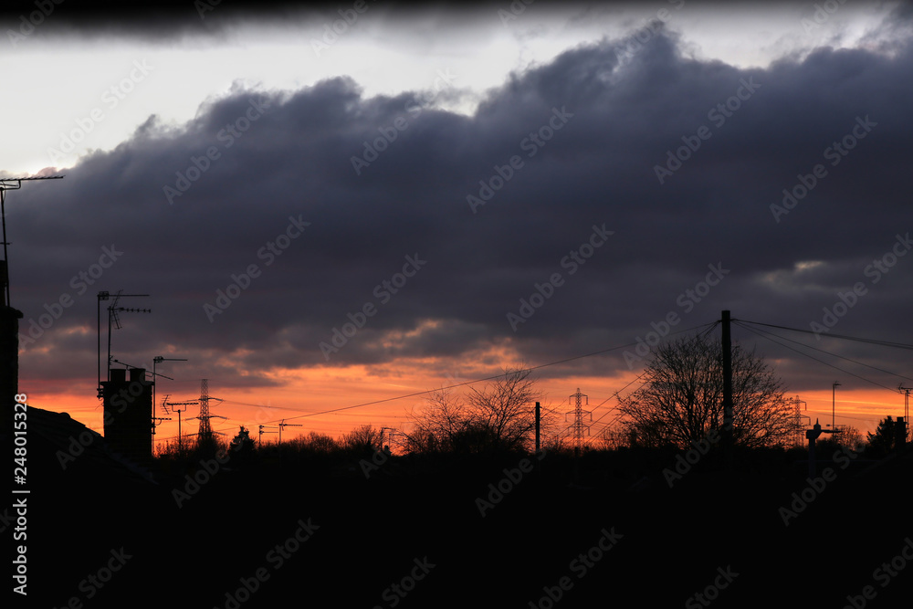 A dramatic rooftops red sky at night silhouette