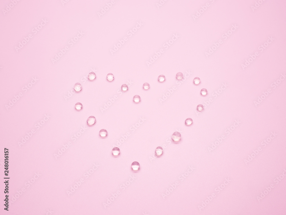 Valentine's day concept with selective focus silica gel in heart shape on pink background.