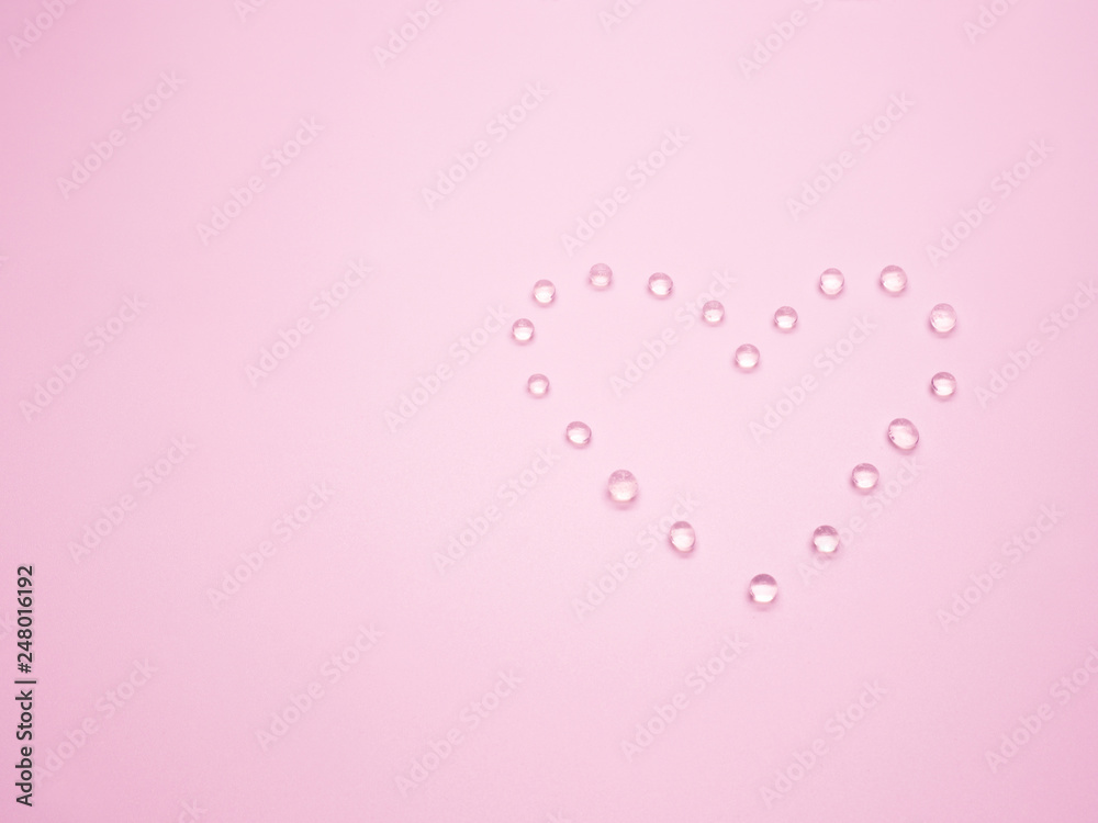 Valentine's day concept with selective focus silica gel in heart shape on pink background.