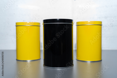 Close-up of yellow and gray tin cans on the gray table