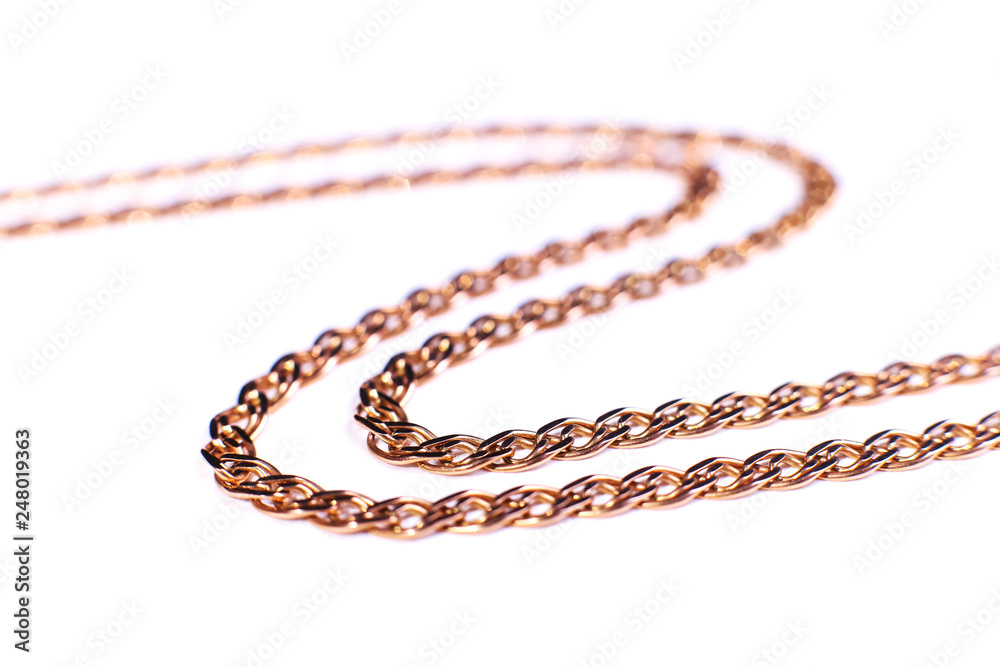 Golden chain weaving non, on a white background. Isolate, macro, soft focus. Golden chain weaving non, on a white background. Isolate, macro, soft focus.