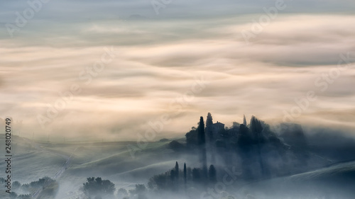 old castle in the fog in Tuscany morning 
