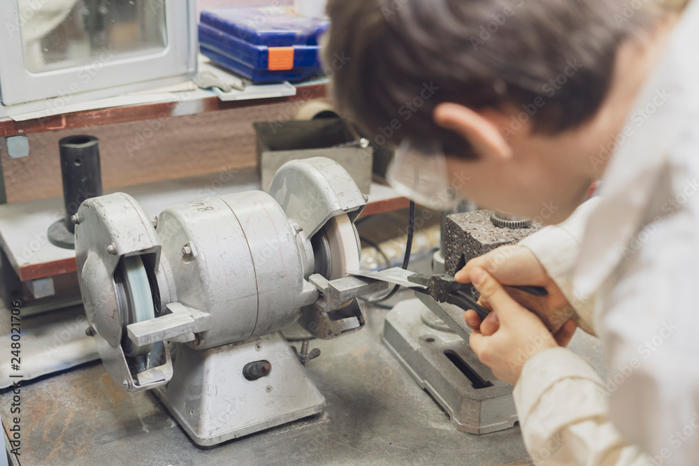 male worker use grindstone at the factory b male worker use grindstone at the factory b