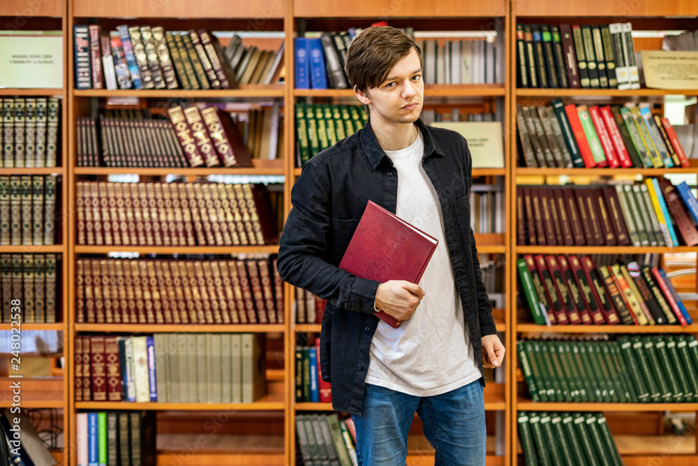 young student portrait in front of book shelf in the library b young student portrait in front of book shelf in the library b