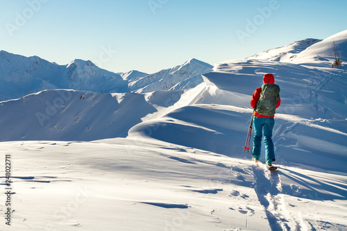 Photos Girl makes ski mountaineering alone toward the mountain pass in a nice track wit