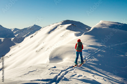 Girl makes ski mountaineering alone toward the mountain pass in a nice track with sealskin