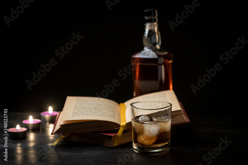a glass of whiskey and a good book