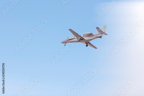 Private jet flying in the blue sky
