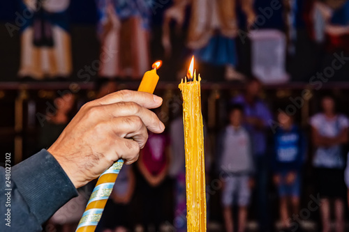 Belgrade, Serbia - May 23, 2018: Lighting candles in a Orthodox church St. Basil of Ostrog (Serbian: Crkva Svetog Vasilija Ostroškog) in Belgrade, Serbia. photo