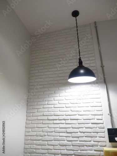 White brick wall decor and ceiling light bulb interior
