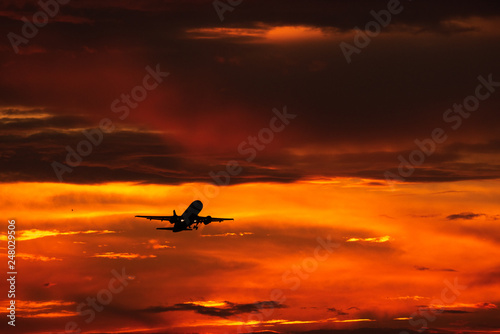 Silhouette of airplane taking of in the sunset  © Eduard