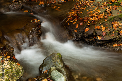 Waterfall inside autumn forest 