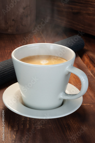 Cup of coffee on wooden table.