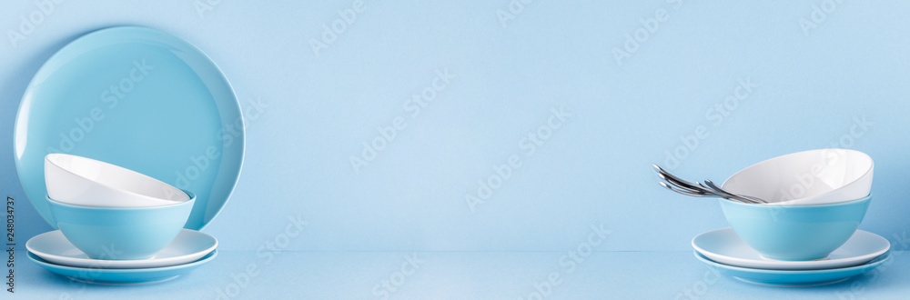 Crockery and cutlery on a blue pastel background
