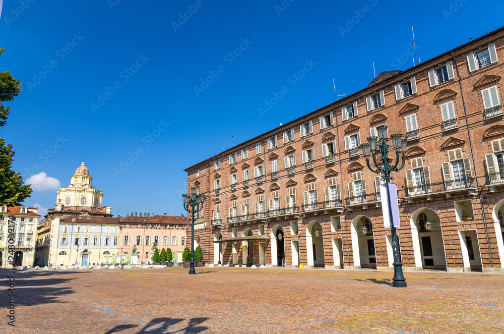 Prefecture Palazzo del Governo Palace buildings and San Lorenzo Saint Lawrence church on Castle Square Piazza Castello in historical centre of Turin Torino city with clear blue sky, Piedmont, Italy