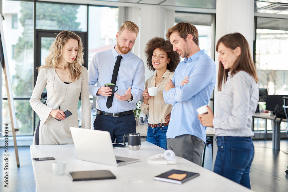 Small group of business people standing at office and solving problem at meeting. Multi cultural group. Small group of business people standing at office and solving problem at meeting. Multi cultural group.
