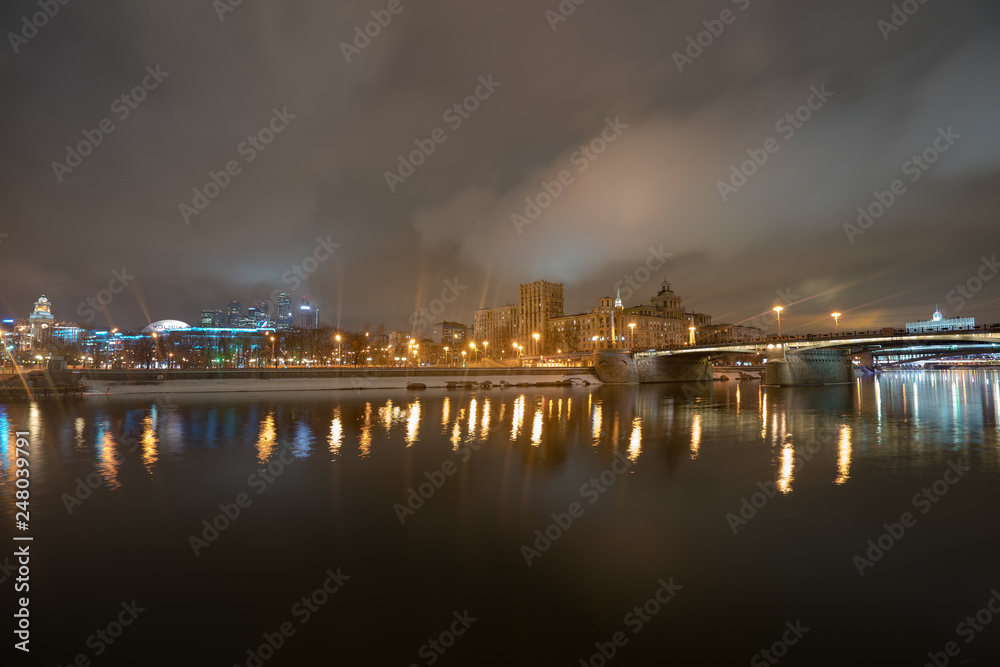 Image of Borodinsky bridge in Moscow at night winter time. MIBC (Moscow Imternational Business Center) in distance