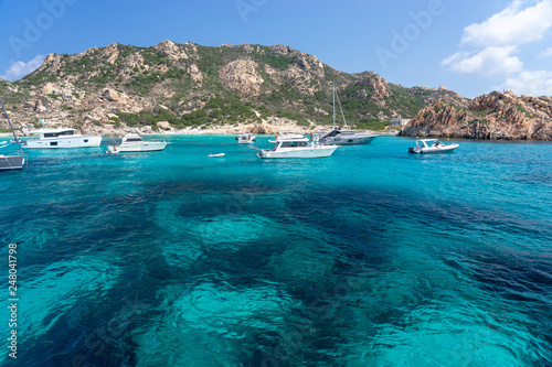 Fototapeta Naklejka Na Ścianę i Meble -  Yachts and boats anchored at beautiful beach of archipelago la Maddalena. Sardinia, Italy