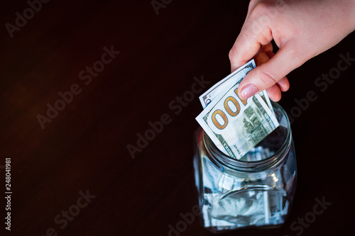 donation jar. gives money to charity with copy space on a dark background photo