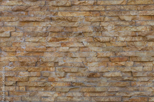 Natural stone granite pieces tiles for walls. Natural stone granite pieces tiles for walls. Wall of stone beige surface bricks as a background.