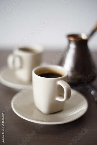 Black Turk coffee brewed in Turkish coffee pot minimalist style