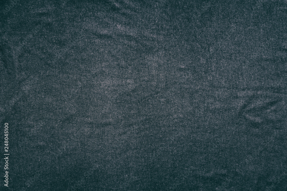 Old t-shirt texture, dark blue stretch fabric background. Analog photo simulation