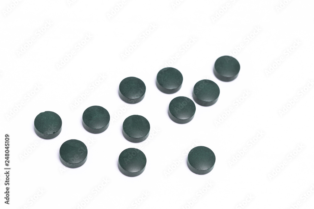 green pills on white background green pills on white background