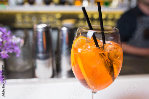 Orange Aperol spritz Cocktail drink -beverage on a bar counter . Selective focus on the foreground glass, Top view . Trendy stylish edit . Copy paste space for design concept service barman concept
