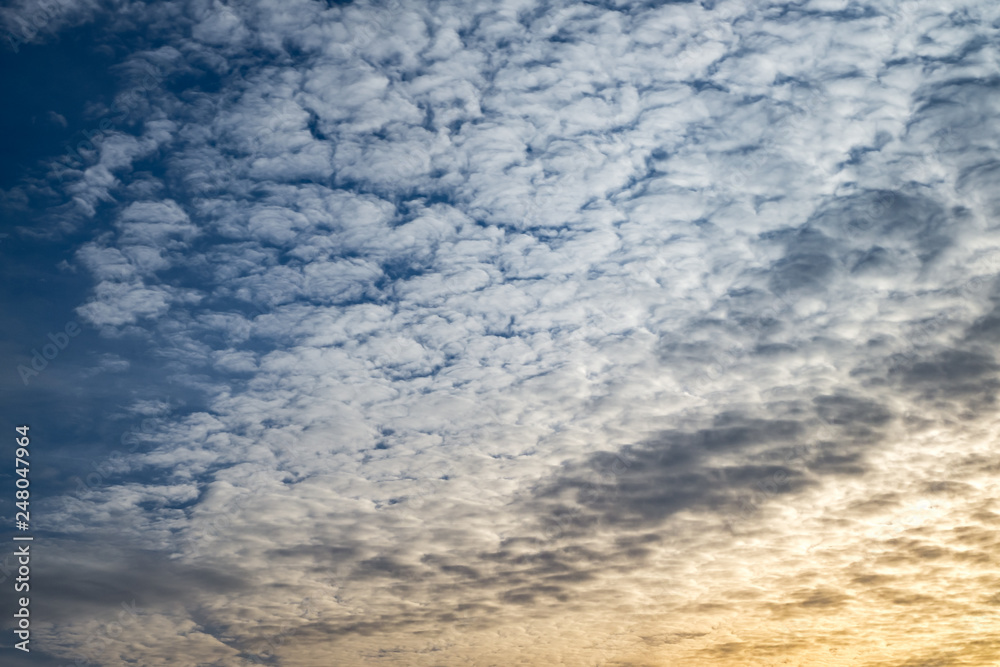 Blue sky background with tiny curly rolling clouds in the evening. Clearing day and Good windy weather Blue sky background with tiny curly rolling clouds in the evening. Clearing day and Good windy weather