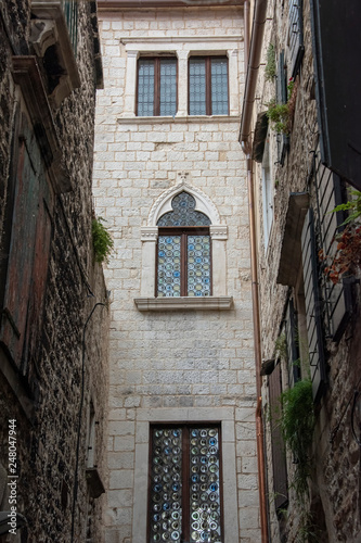 Fototapeta Naklejka Na Ścianę i Meble -  Croatia, Split - June 2018: View of the Cathedral tower though the narrow streets of the town