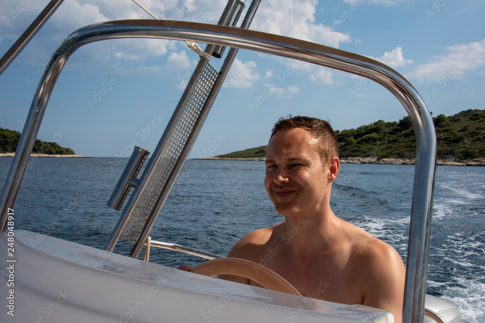 Man  driving a speed boat during vacation