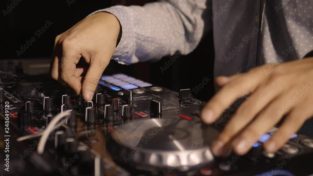 DJ turns the records at the club hand view in modern nightclub DJ turns the records at the club hand view in modern nightclub