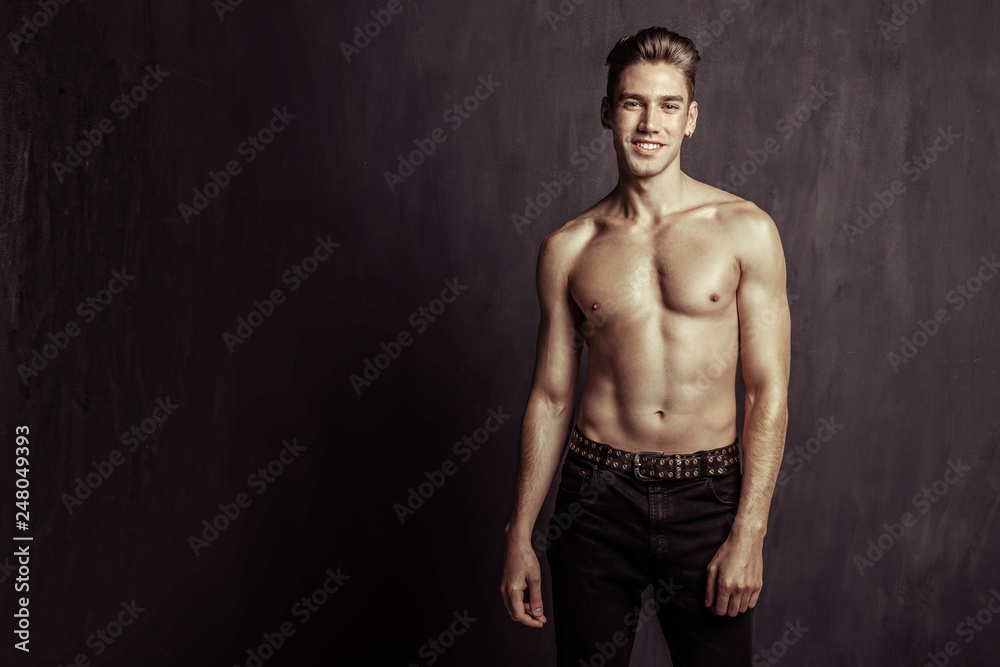 Fototapeta premium Handsome attractive young man smiling to you