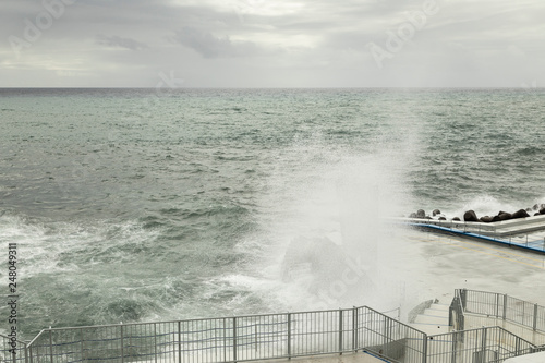 Ghost Tower   An image of sea spray covering a lifeguard lookout tower creating a ghostly appearance shot on the south coast of Madeira Island  Portugal.