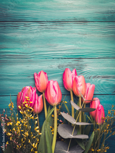 Beautiful tulips on dark green background
