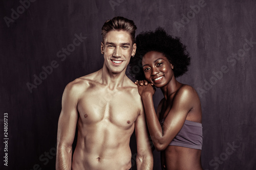 Delighted nice multiethnic couple feeling great together