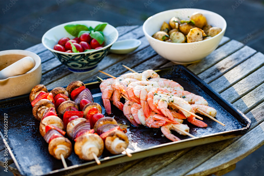 refreshing summer barbecue skewers with shrimps and vegetables