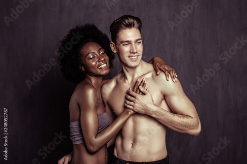 Delighted afro American woman feeling her boyfriends heartbeat