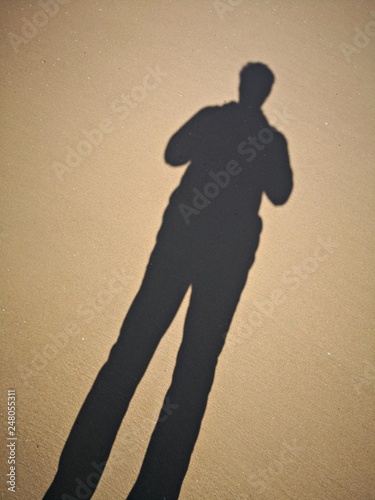Shadow of a man on the sand in the desert 