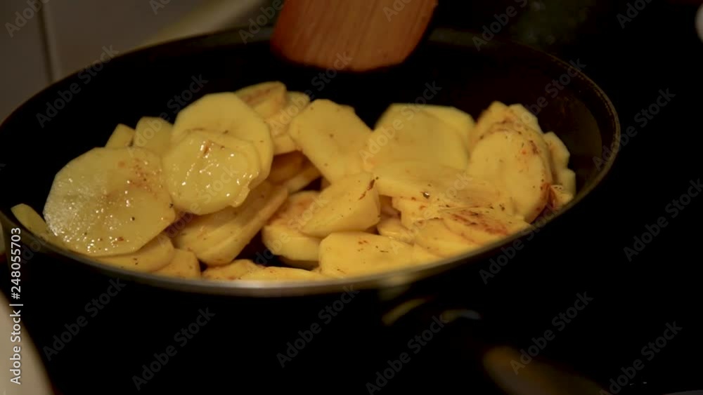 Potatoes Frying Process. Mixing The Fried Potatoes Potatoes Frying Process. Mixing The Fried Potatoes