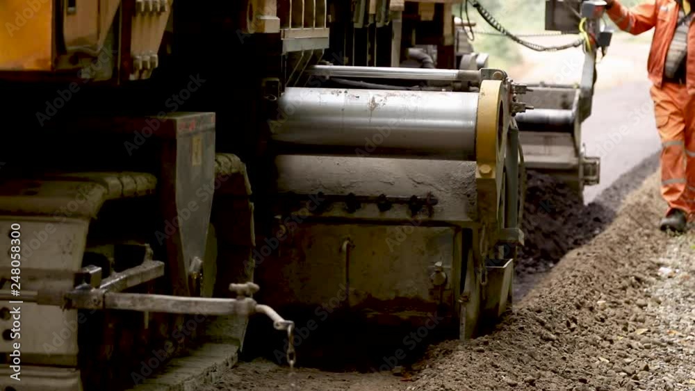 Machine with caterpillar wheels move though the road. Asphalt Machine with caterpillar wheels move though the road. Asphalt
