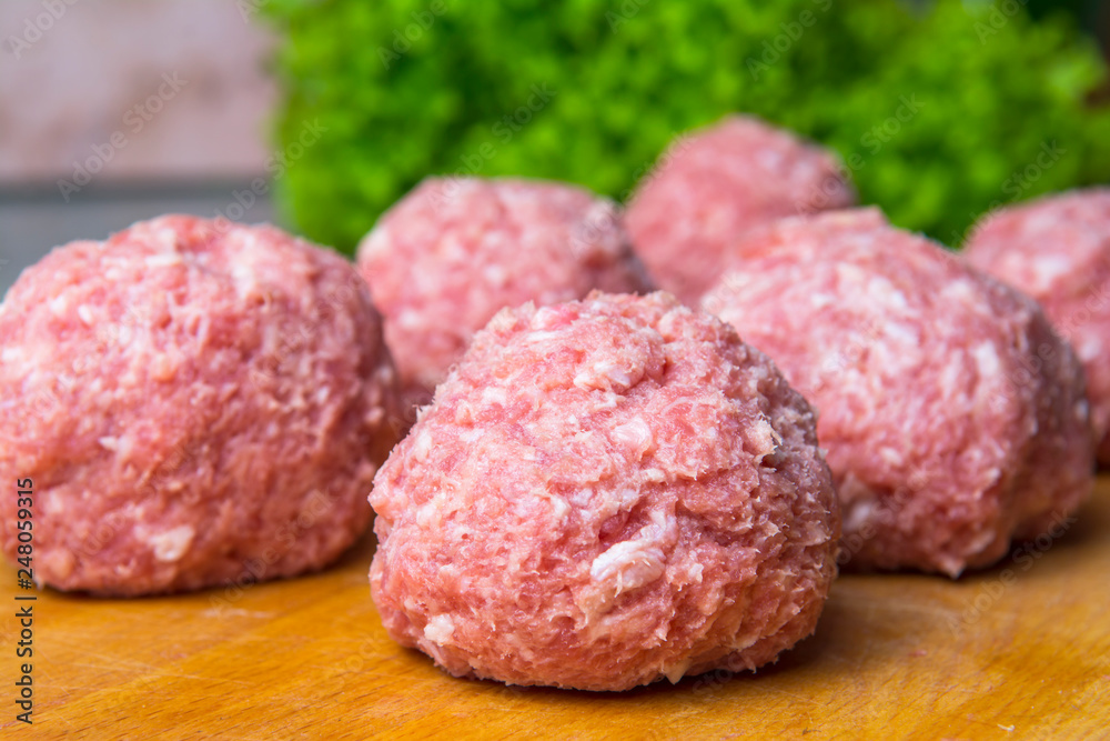 raw mince patties in a cooking . cutlets are prepared for cutting board raw mince patties in a cooking . cutlets are prepared for cutting board