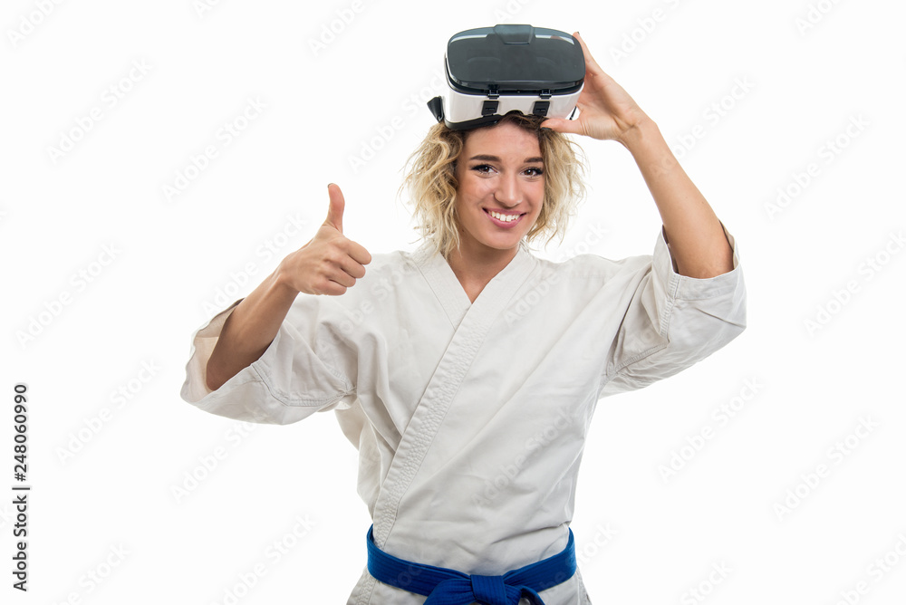 Portrait of female wearing martial arts costume holding vr glasses