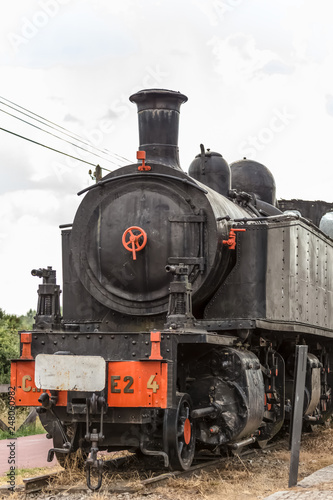 Front view of old train with dramatic sky