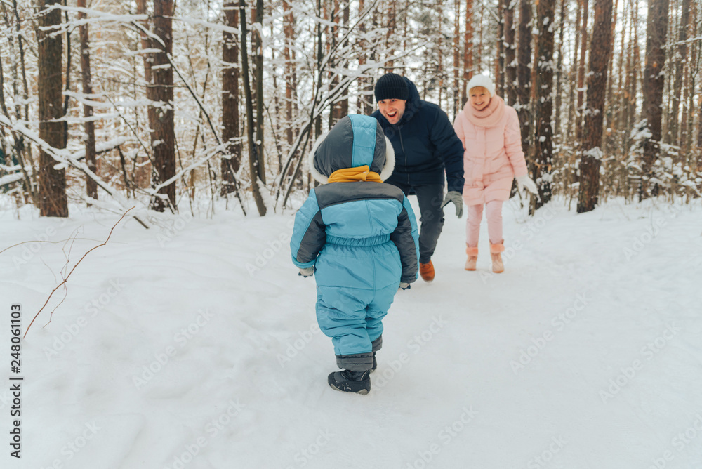 Walking family with a child. Family walks in nature in winter. Winter family walk in nature. A lot of snow. Walking family with a child. Family walks in nature in winter. Winter family walk in nature. A lot of snow.