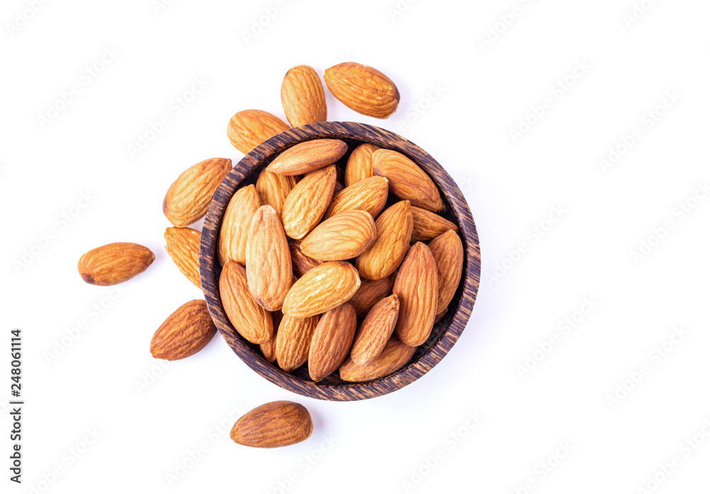 Almond Nuts in wood bowl isolated on white background. top view Almond Nuts in wood bowl isolated on white background. top view