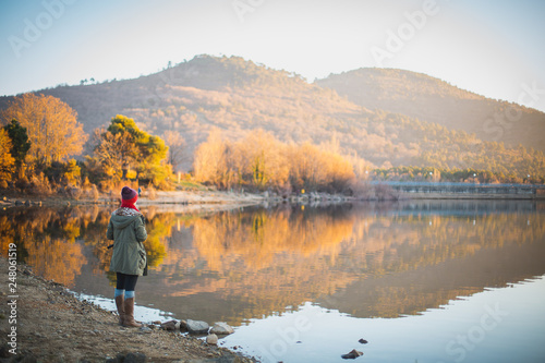 young woman looking lake landscape