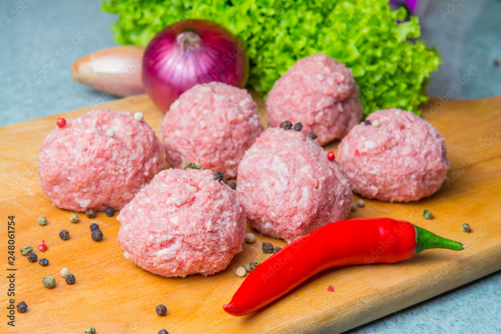 raw mince patties in a cooking . cutlets are prepared for cutting board raw mince patties in a cooking . cutlets are prepared for cutting board